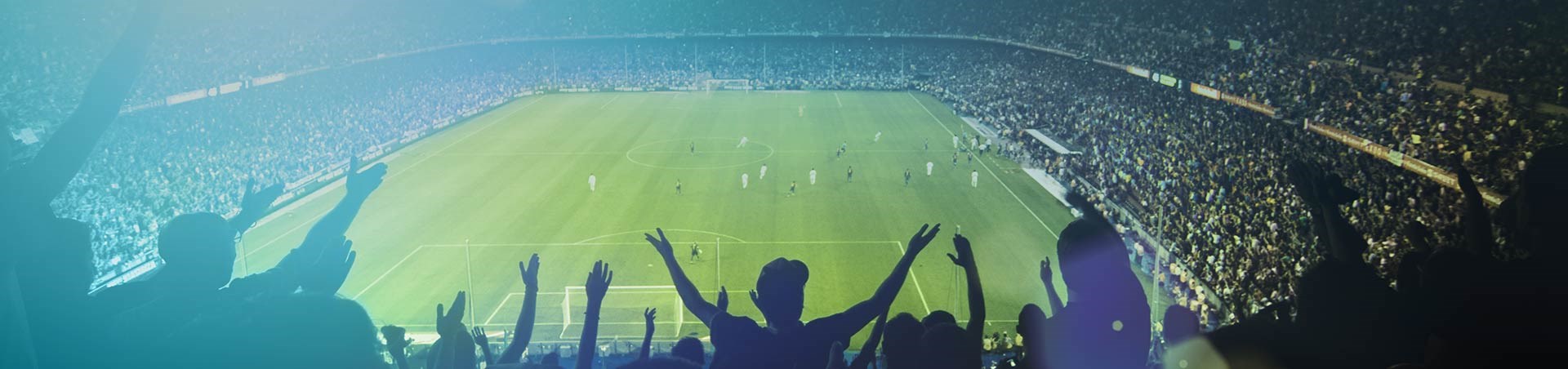 Crowd inside a stadium watching a football game